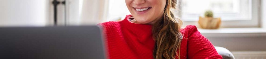 woman sitting at desk typing on a computer