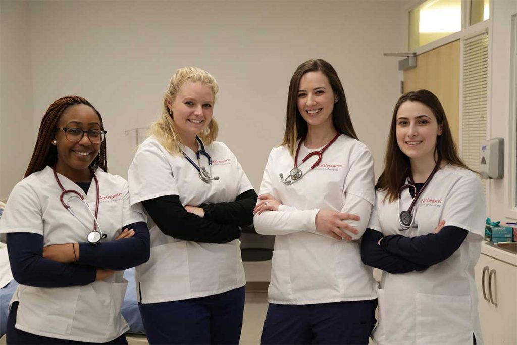 Northeastern nursing students posing and smiling