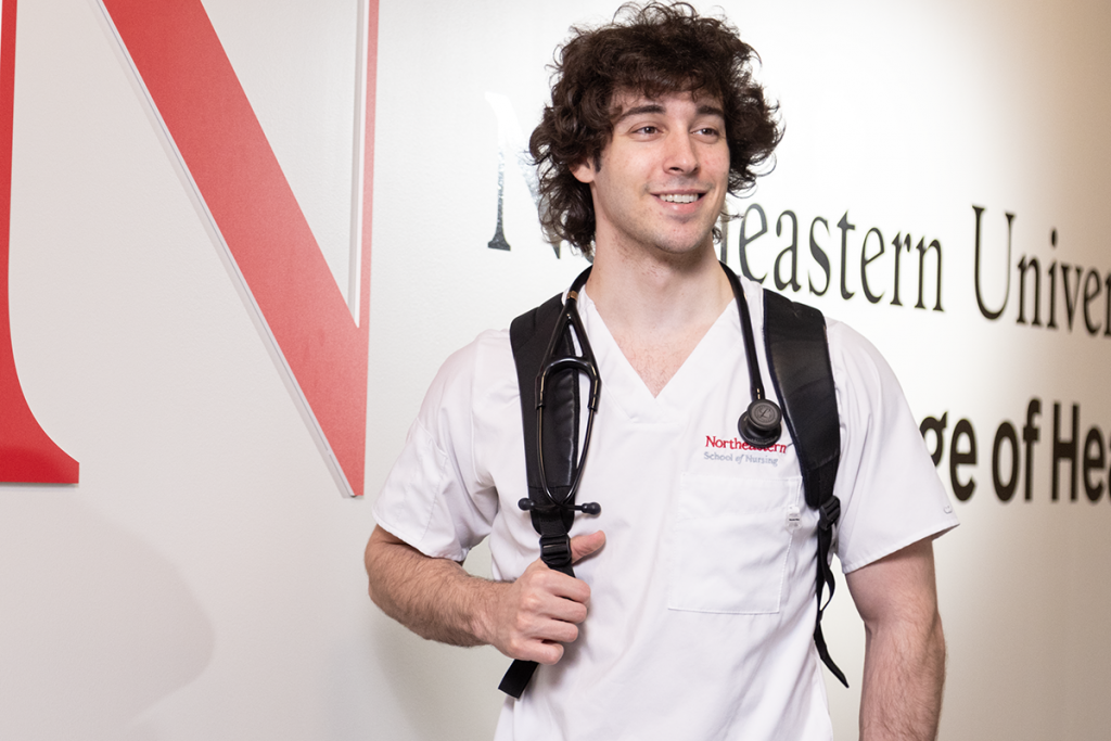 nurse in front of logo