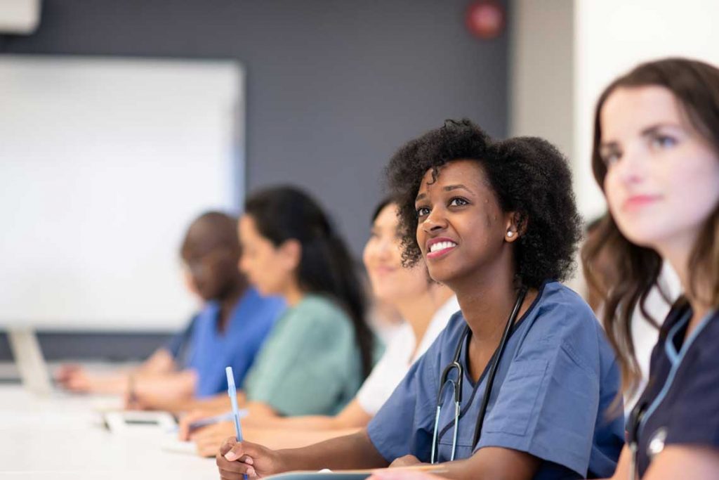 nursing students take notes during a lecture