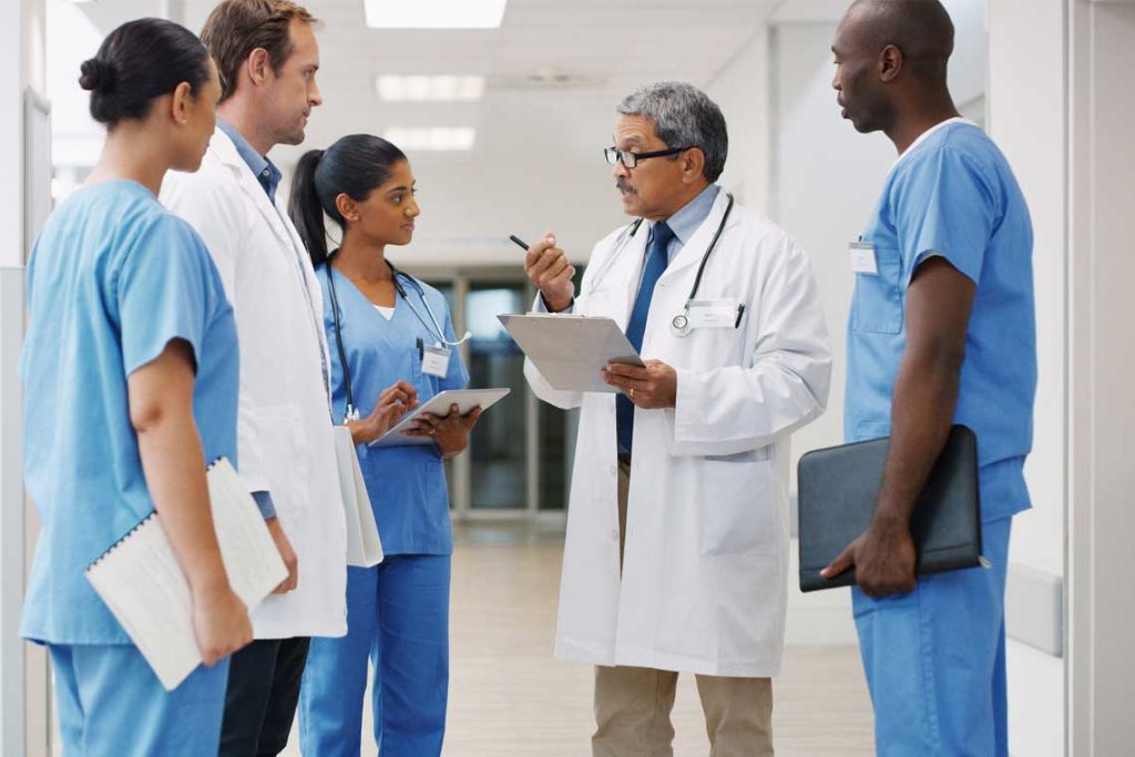 nurses speaking with doctor in hospital