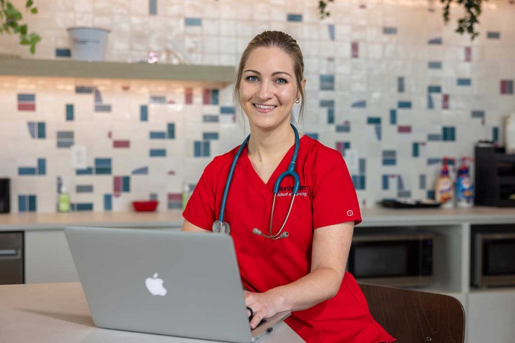 NEU nursing student using laptop