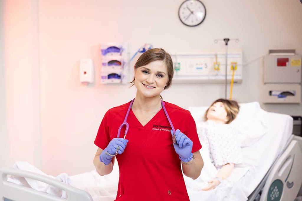 smiling NEU nursing student in sim lab