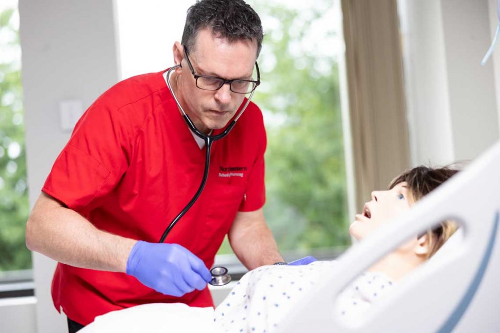 NEU nursing student working in sim lab