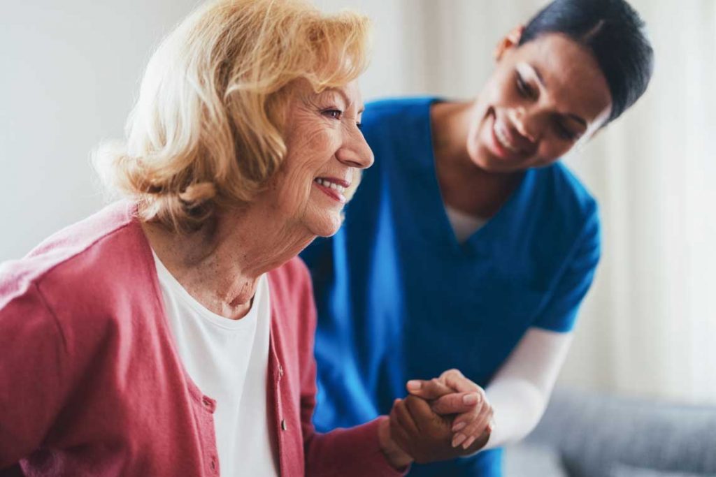 nurse helping older patient