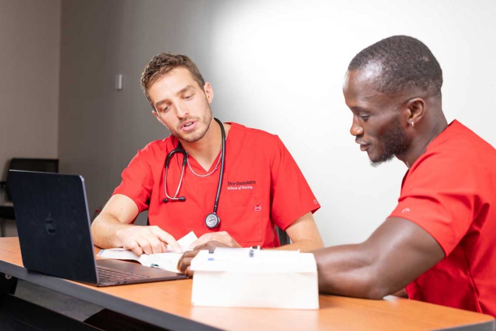 Two NEU nursing students studying at table